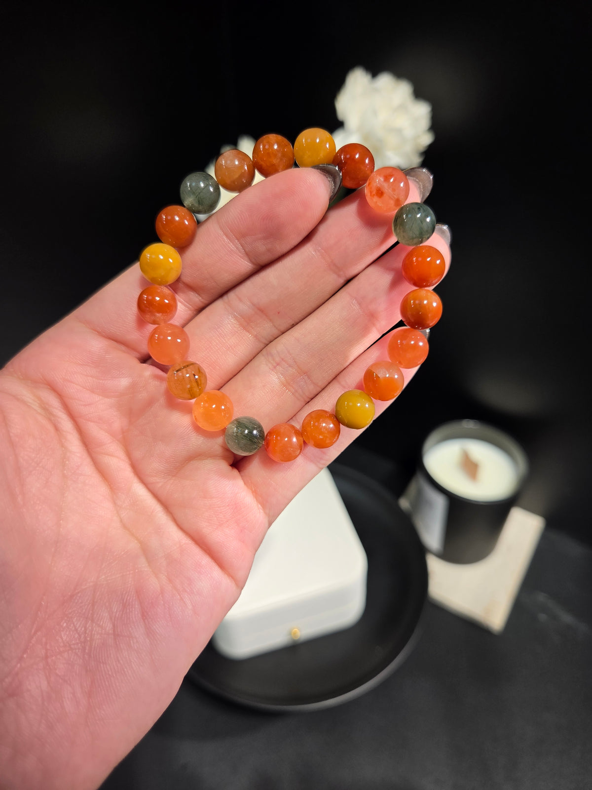 Hand holding light luxury multi-gemstone beaded crystal bracelet showing bead details