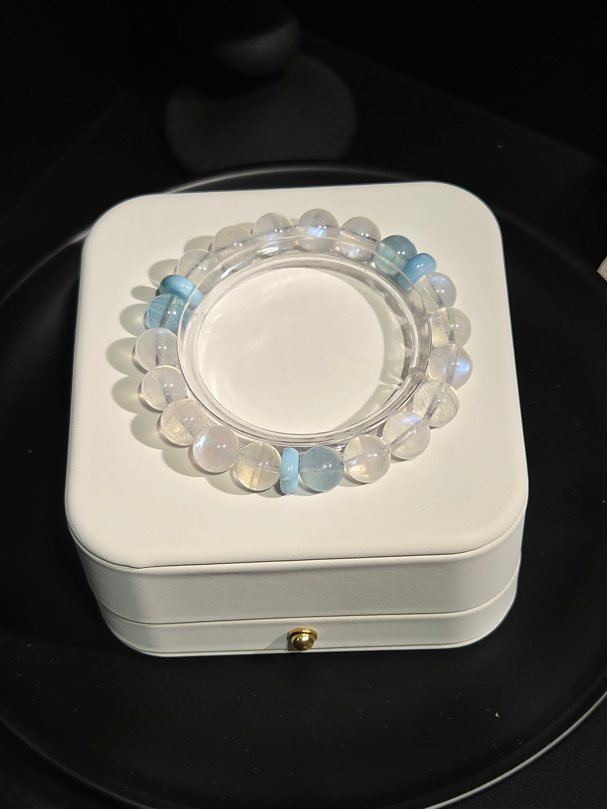 Light luxury blue sheen moonstone and aquamarine beaded crystal bracelet on display stand